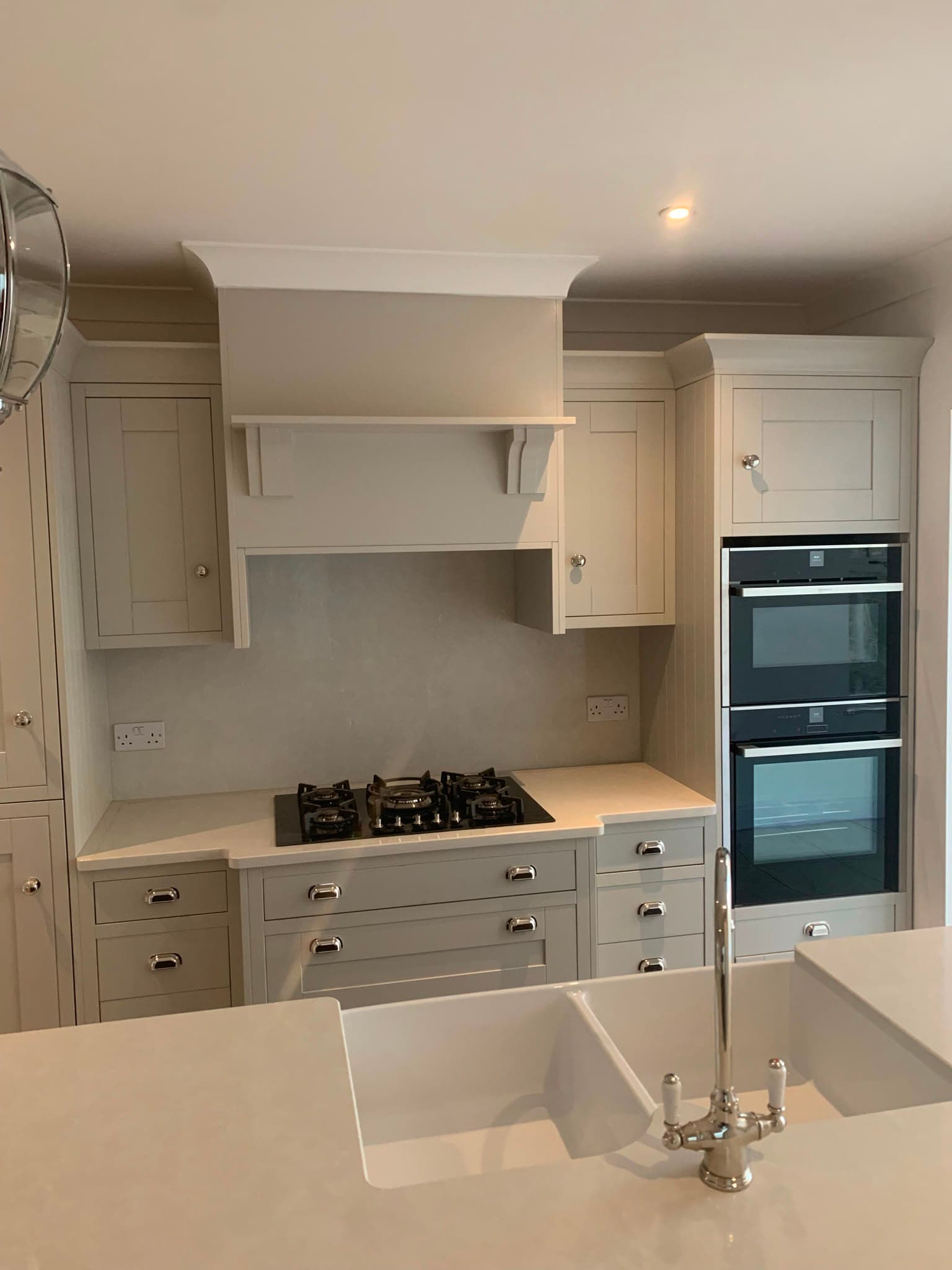 Fitted shaker kitchen with range-style canopy, double oven and belfast sink by WMC Property Maintenance