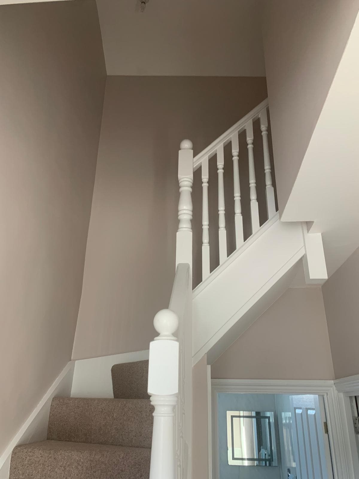 Freshly painted staircase, hallway and gloss-white balustrade by WMC Property Maintenance